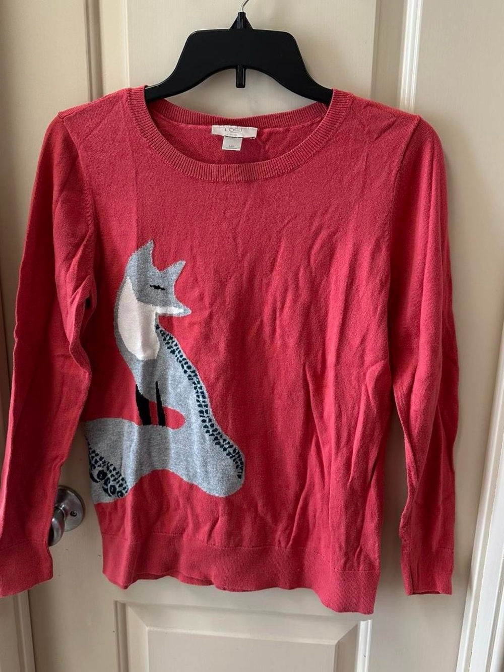 Red sweater with grey fox design.